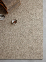 Armadillo Pebble Rug in Whippet, a second view of the handwoven boucle wool rug in a styled interior