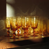 Hand-blown amber Italian goblet styled with red wine