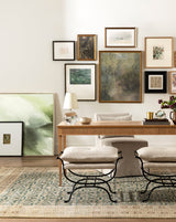 Pieter desk against a gallery wall with two stools