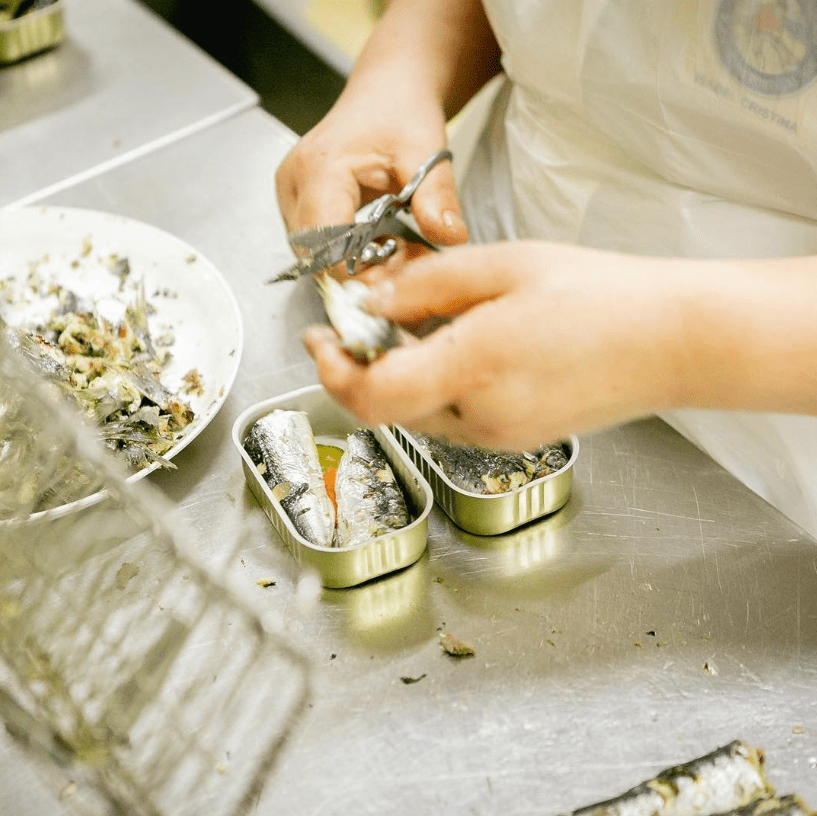 Open tin of Pinhais spiced sardines with contents visible