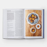 Calimia Home Portugal: The Cookbook open to a page featuring a recipe for Custard Tarts with photos of pastries and coffee
