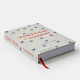 Calimia Home Portugal: The Cookbook featuring a white cover with blue tile patterns and red text.