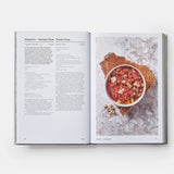 Calimia Home Portugal: The Cookbook open to a page featuring a recipe for Alentejo-style gazpacho with a photo.