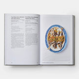 Calimia Home Portugal: The Cookbook open to a page featuring a fried baby horse mackerel recipe with food photography.