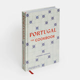 Calimia Home Portugal: The Cookbook featuring a white cover with blue azulejo tile patterns and red text.
