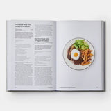 Calimia Home Portugal: The Cookbook open to a page featuring a recipe for Portuguese steak with an egg on horseback.