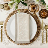 Maison Venu Primrose Sand napkins featuring a hand block-printed floral silhouette and contrasting border trim.