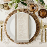 Maison Venu Primrose Sand napkins featuring a hand block-printed floral silhouette and contrasting border trim.