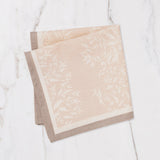 Maison Venu Primrose Sand napkin set of 4 featuring a hand block-printed floral silhouette and contrasting trim.