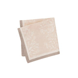 Maison Venu Primrose Sand napkins featuring a hand block-printed floral silhouette and a contrasting border trim.