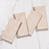 Maison Venu set of 4 Primrose Sand napkins featuring hand block-printed floral silhouettes and contrasting trim.