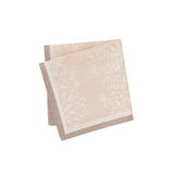 Maison Venu Primrose Sand napkins featuring a hand block-printed floral silhouette and a contrasting border trim.