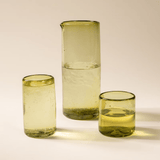 Peridot recycled glass collection styled together — pitcher with tall and short tumblers
