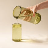 Side view of the peridot recycled glass pitcher showing its tall cylindrical form