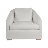 Calimia Home Reily upholstered chair in off-white Belgian linen with rounded back, sloped arms, and oak feet.