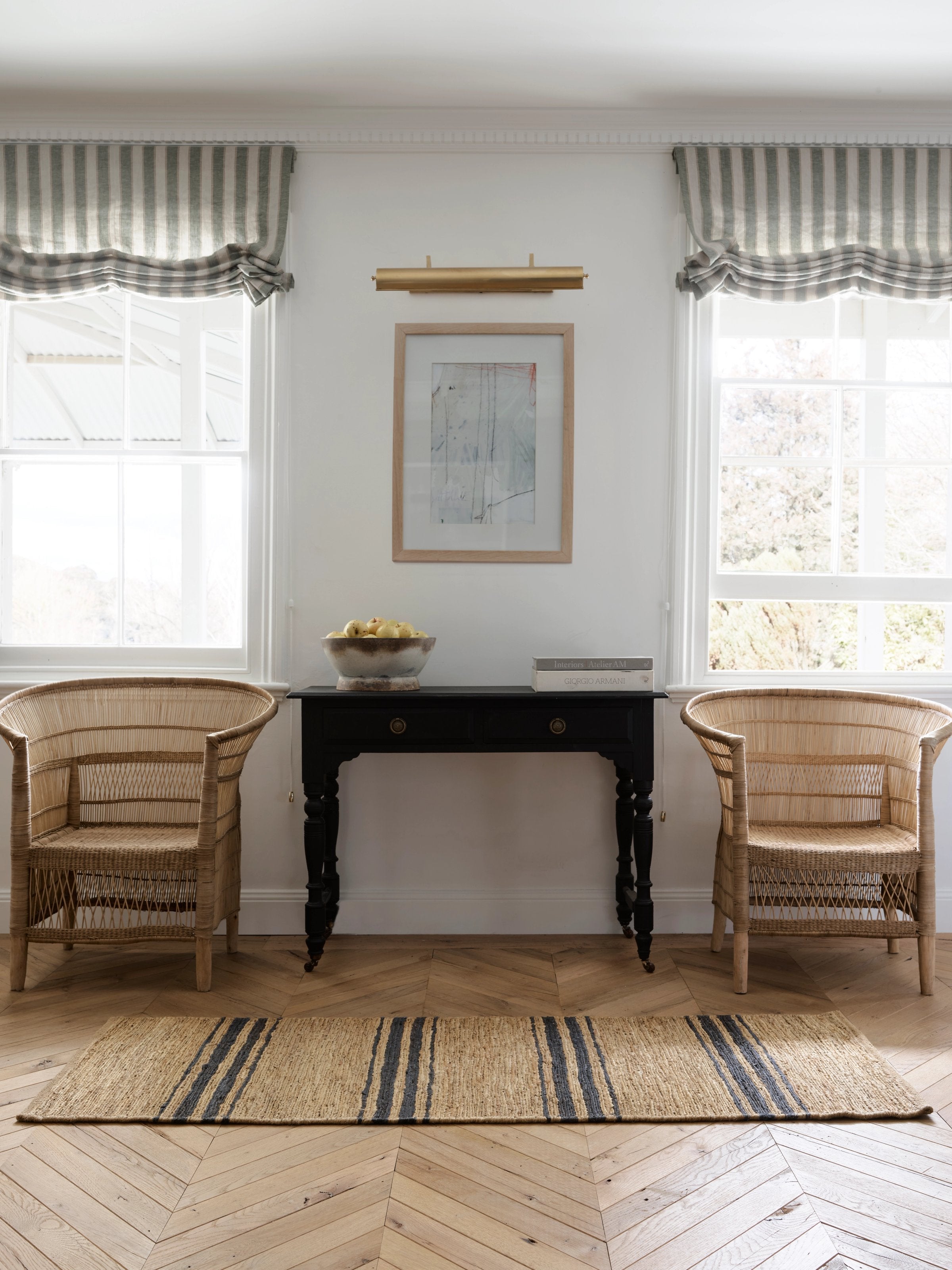 Armadillo River Nook Rug in Natural & Indigo, handwoven jute rug shown in a room setting