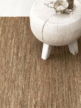 Armadillo River Rug in Natural, a second view of the handwoven jute rug in a styled interior