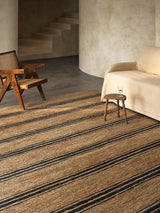 Armadillo River Rug in Natural & Indigo, a second view of the handwoven jute rug in a styled interior