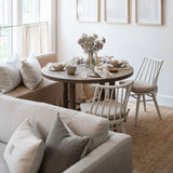 Calimia Home River Rug with rippled texture in a neutral dining room setting with wooden furniture