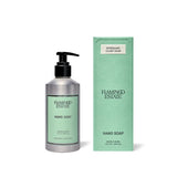 A brushed aluminum Flamingo Estate Rosemary Clary Sage Hand Soap pump stands beside its sage-green box on a white surface, retail-ready.