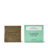 Flamingo Estate Rosemary & Parsley Soap Brick beside its mint-green 12 oz carton labeled Rosemary Green Leaf Parsley.