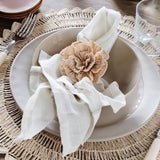 Pom Pom At Home Rutherford natural napkins with stitched stripes and a decorative flower napkin ring on a table setting