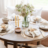 Pom Pom At Home Rutherford natural linen napkins with stitched stripes set on a rustic dining table with floral decor