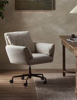 Salerno desk chair in Crete Sand at a wooden desk in a styled office