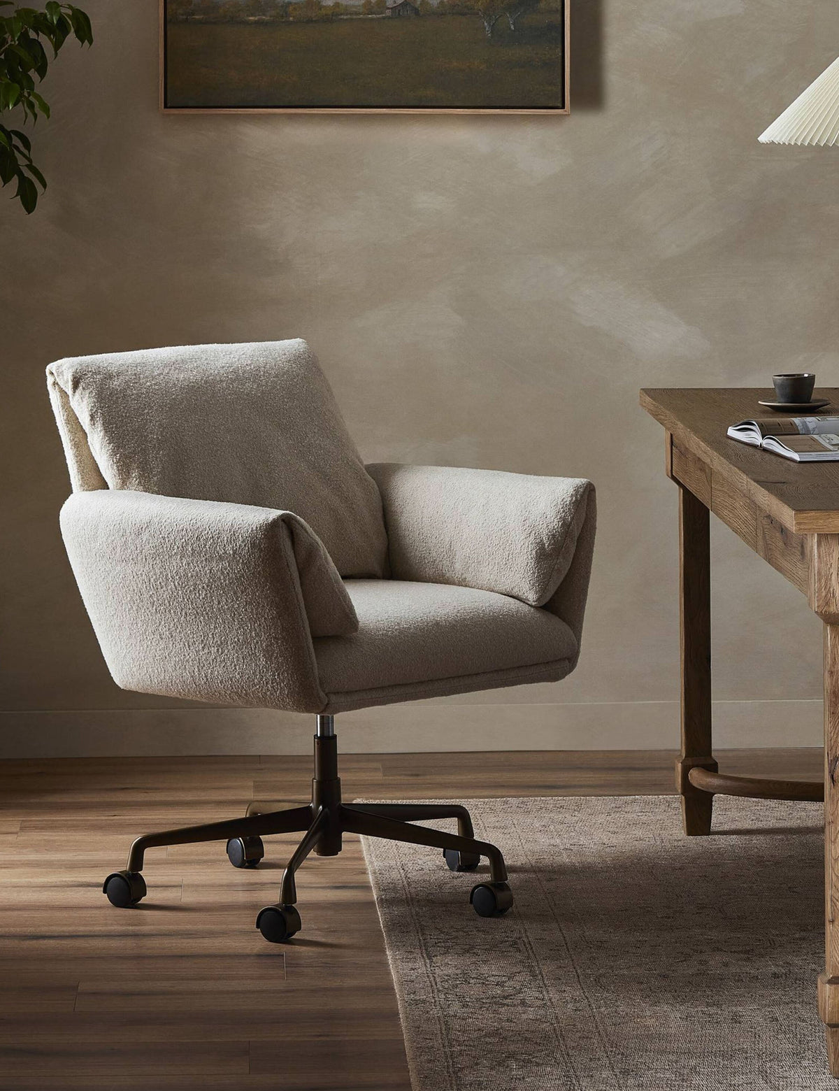 Salerno desk chair in Crete Sand at a wooden desk in a styled office