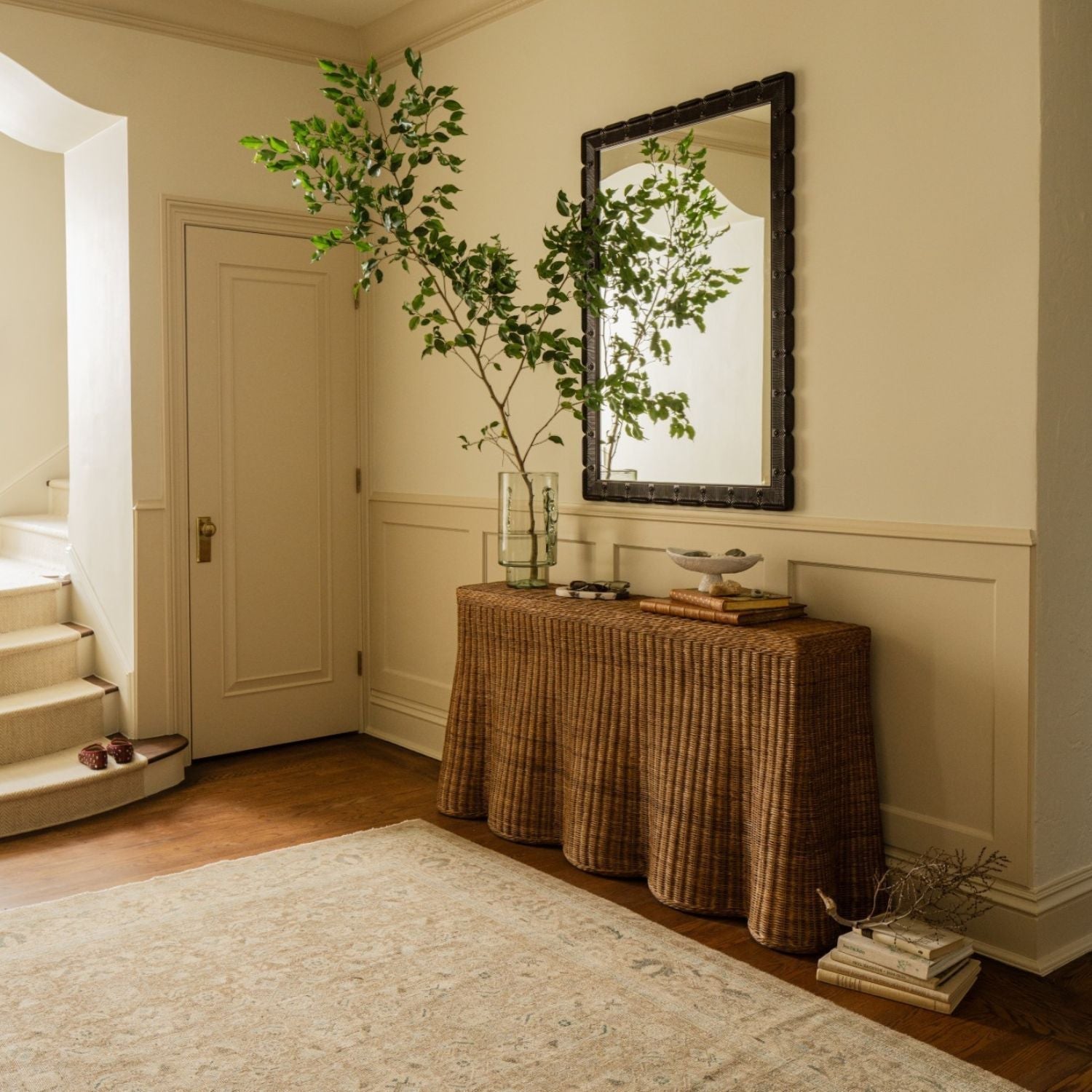 Calimia Home Scallop Console in chestnut rattan with a scalloped edge, styled in a bright entryway with a mirror.