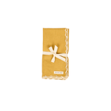 Maison Poire mustard cotton linen napkin with an ivory scalloped edge, folded and tied with ribbon