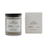 Frama 1917 scented candle in a glass jar with a black lid and matching white box, featuring floral earthy notes.