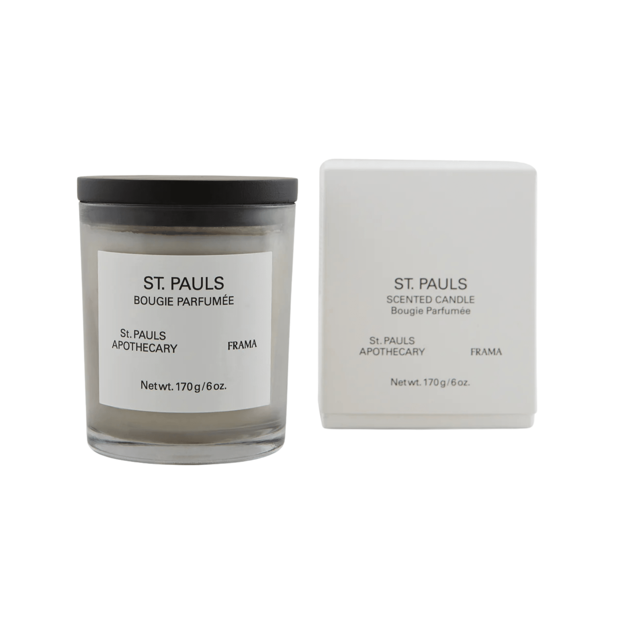 A glass jar Scented Candle - St. Pauls sits beside its white box, both with minimalist black text from the Apothecary Collection, showcasing the signature fragrance by St. Pauls Apothecary and Frama.