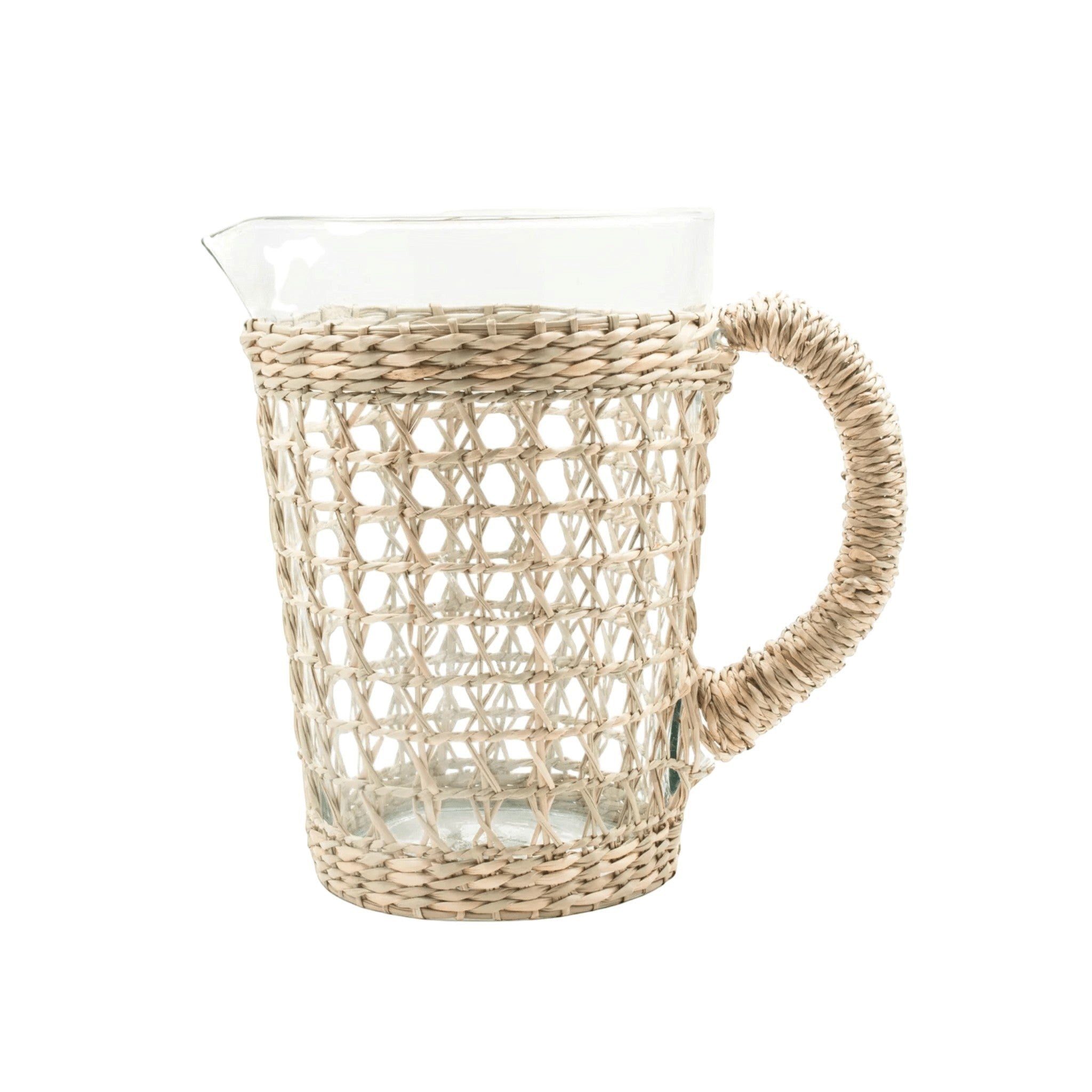Be Home clear glass pitcher wrapped in handwoven natural seagrass with a sturdy woven handle and pour spout.