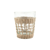 Calimia Home glass tumbler featuring a hand-woven natural seagrass cage sleeve for a coastal artisanal aesthetic.