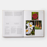 Calimia Home The Seasonal Gardener book open to a spread showing an anemone and red flower pairing.
