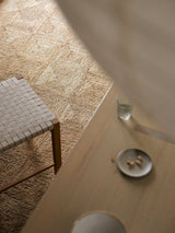 Armadillo Sequoia Rug in Natural, a second view of the hand-stitched jute rug in a styled interior
