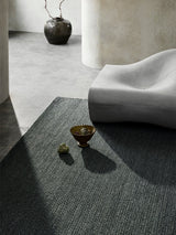 Armadillo Sherpa Rug in Kelp, a second view of the handwoven wool blend rug in a styled interior