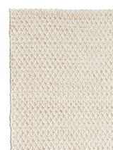 Armadillo Sherpa Rug in Sand, corner close-up of the wool and viscose blend pile and edge