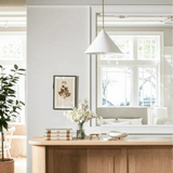 Slide Drop Pendant above the white oak counter with black stools at Calimia Home