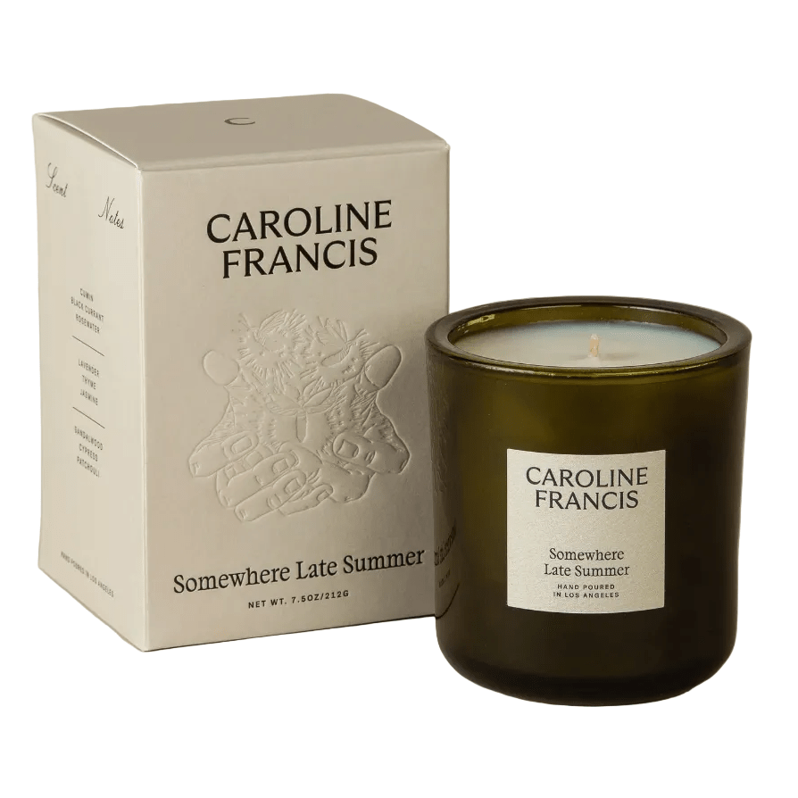 Caroline Francis candle and packaging on a beige background