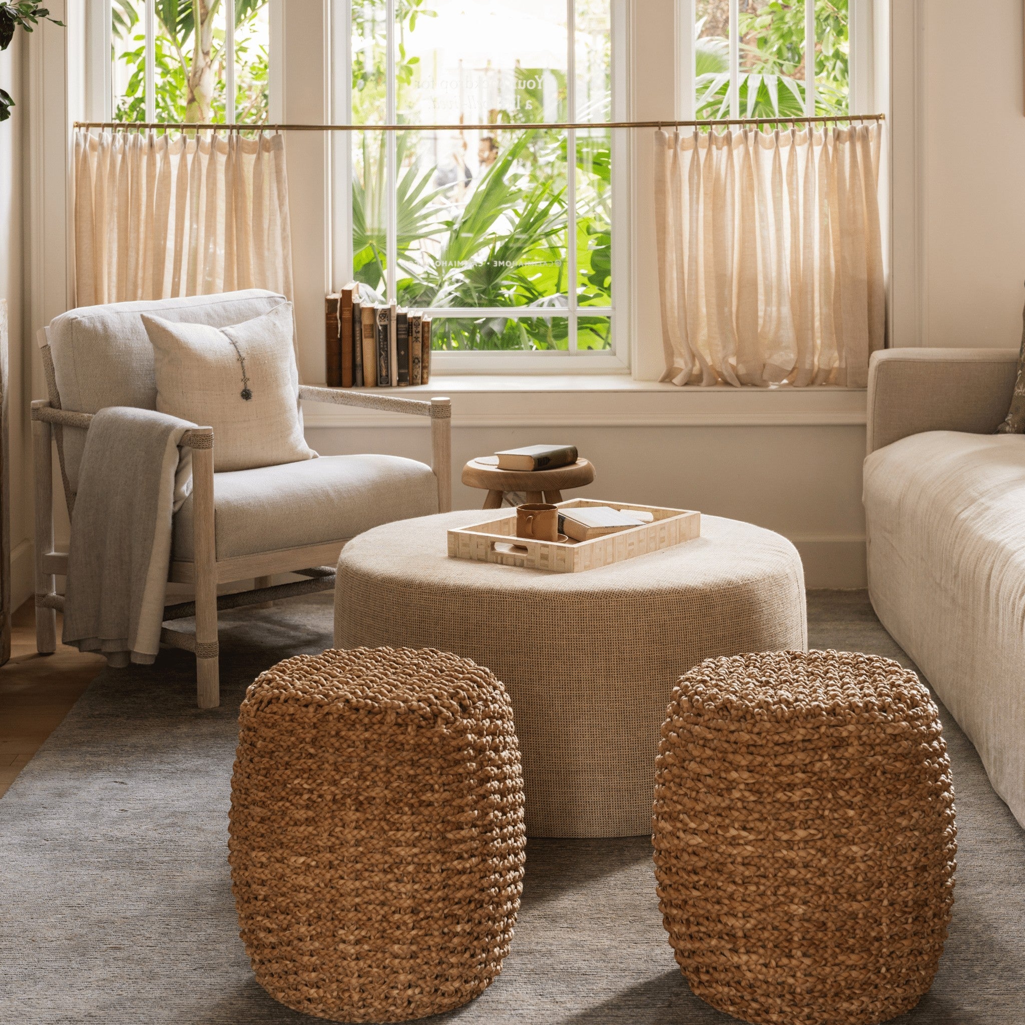 Calimia Home Spa Round Drum stools made of hand-braided natural seagrass placed in a bright, organic living room.