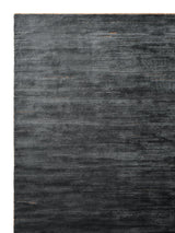 Armadillo Staccato Rug in Nightfall, corner close-up of the silk, linen, and cotton pile and edge