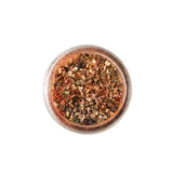 Calicutts Steakhouse Spice Blend featuring a smoky mix of salt, herbs, and red pepper flakes in a glass jar.