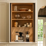 Calimia Home stoneware mugs arranged on a shelf in a modern kitchen coffee station with coffee makers