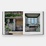Calimia Home Summer by the Sea book open to a spread showing a garden shed and a sunlit sleeping porch.