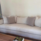 Textural Woven Pillow by One Bi One styled on an ivory sofa