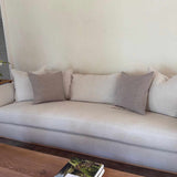 Textural Woven Pillow by One Bi One styled on an ivory sofa