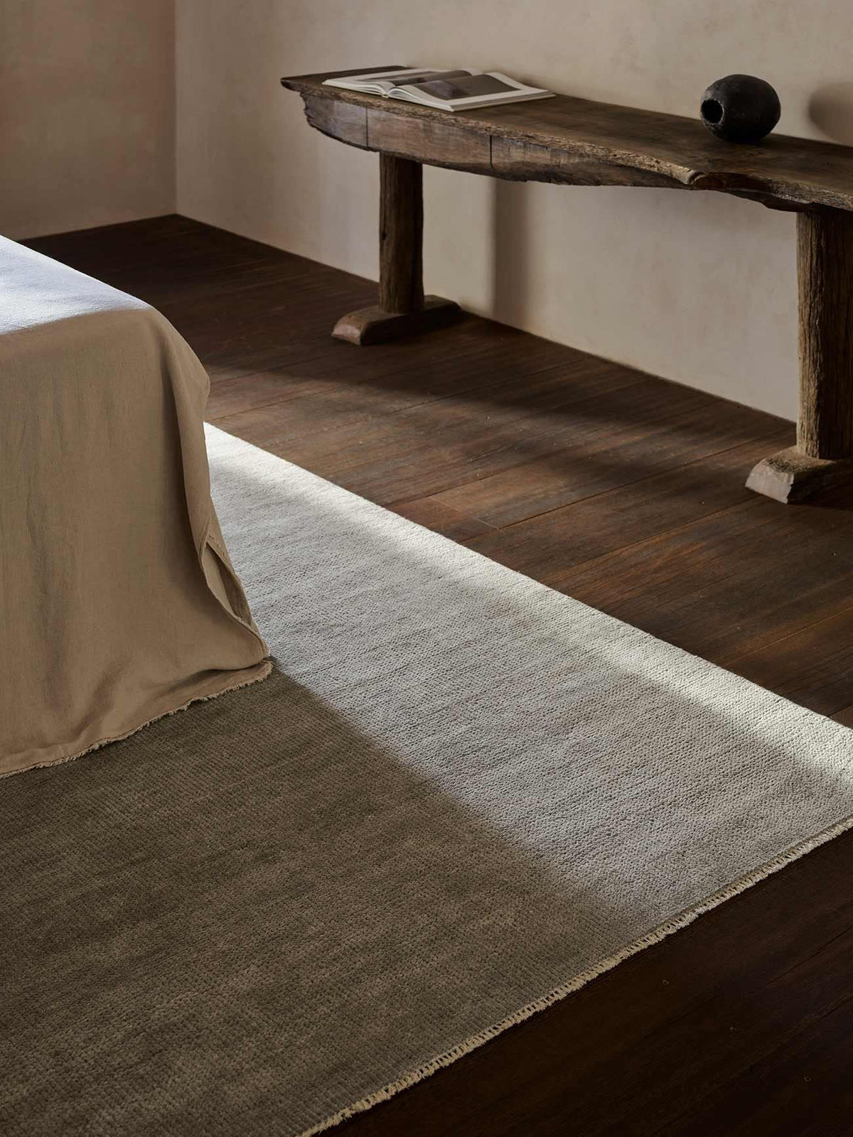 Armadillo Thatch Rug in Concrete, hand-knotted wool rug shown in a room setting