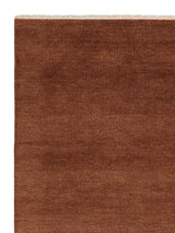 Armadillo Thatch Rug in Copper, corner close-up of the wool pile and edge